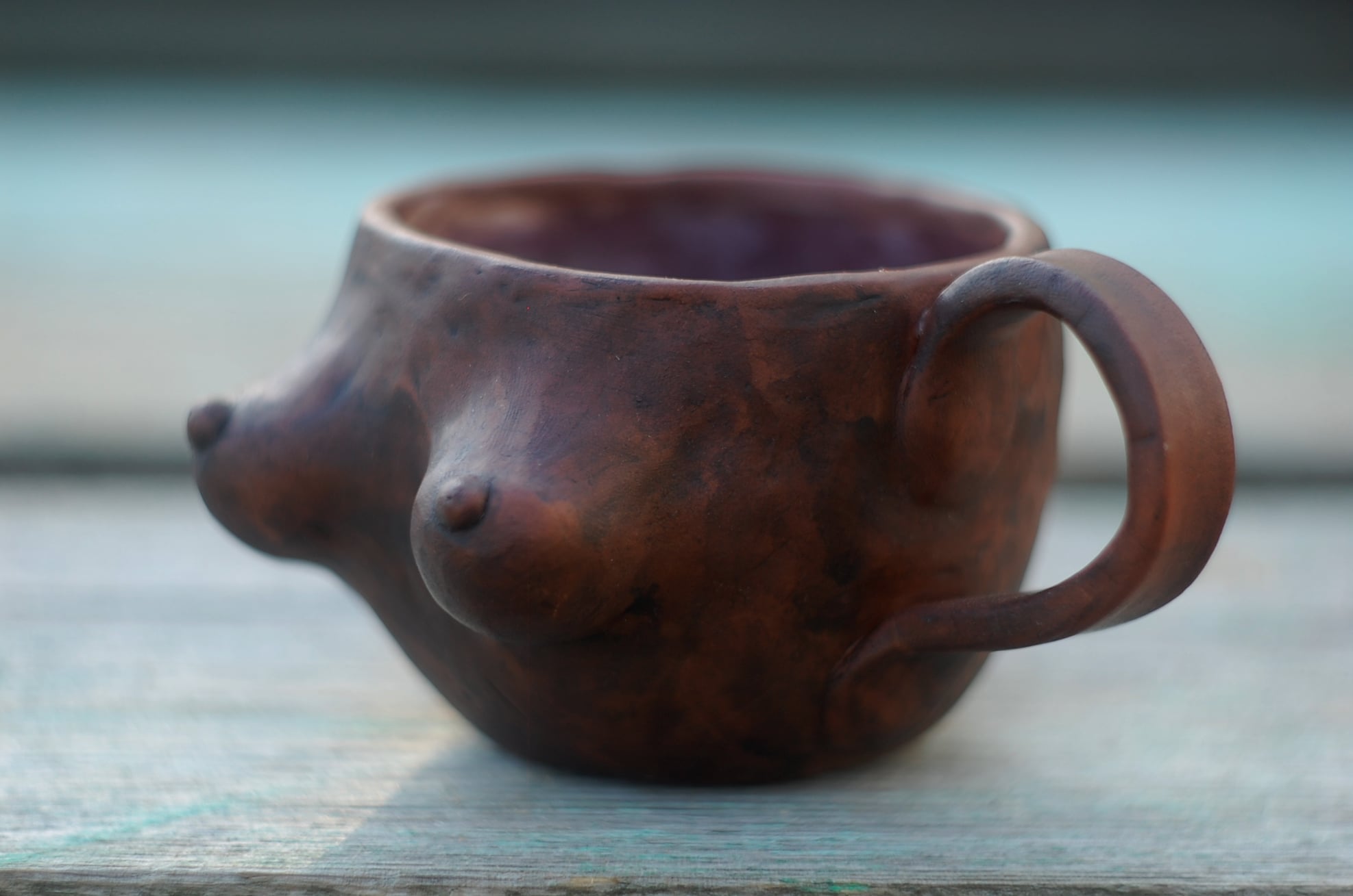 Pottery breast mug
